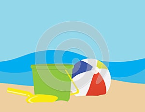 Colorful beach ball, Green toy bucket and Yellow toy shovel on Brown sand,