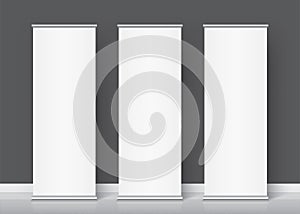 White roll-up banners standing on the floor.