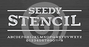 Seedy Stencil alphabet font. Scratched vintage letters and numbers. Wooden background. photo