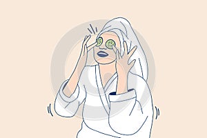 Illustrations of Beautiful young woman in bathrobe applying a natural facial mask cucumber slices on face