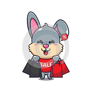 cute rabbit with shopping bag in black friday sale cartoon vector illustration.