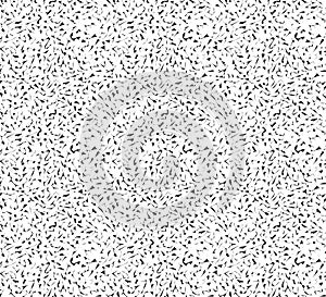 Dense pattern of small black abstract shapes on a white background.