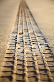 Print of a tyre tread on a sand