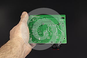 Printed circuit board green in the hand of the master