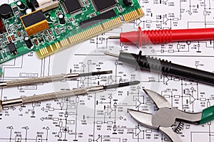 Printed circuit board. precision tools and cable of multimeter on diagram of electronics