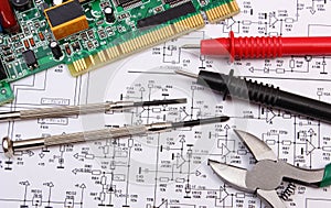 Printed circuit board. precision tools and cable of multimeter on diagram of electronics