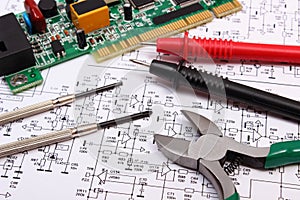 Printed circuit board. precision tools and cable of multimeter on diagram of electronics