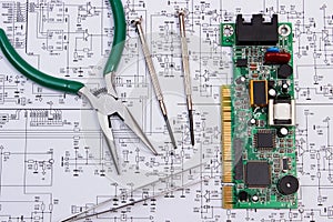 Printed circuit board and precision tools on diagram of electronics, technology