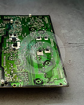 Printed green circuit board, isolated on concrete background