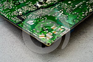 Printed green circuit board, isolated on concrete background