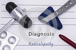 Printed medical form with text diagnosis Radiculopathy, two medical neurological reflex hammers, medicine pills in a blister pack