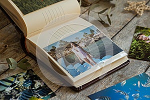 Printed photos in picture album. Summer memories.