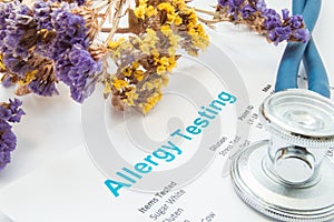 Printed result of allergy test blood or skin lies next to flowers with falling pollen and stethoscope. Concept photo for analysi