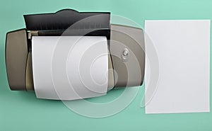 A printer with blank paper forms on a blue background. Top view, flat lay