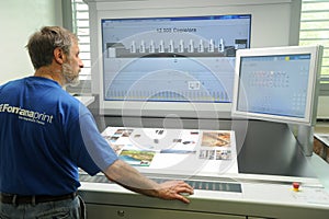 Printer checking a print run at table