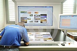 Printer checking a print run at table