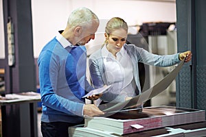 Printing industry, tablet and people with paper for communication in creative sector, warehouse and factory for design