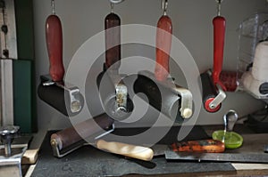 Printmaking rollers hanging on an art studio wall photo