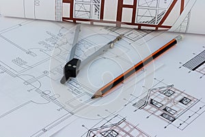 Printouts of house plan drawings on the table