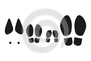 Prints of the soles of a family of four. Set of black icons on white backgroun d.