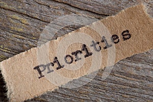 Priorities - word on a piece of paper close up, business creative motivation concept