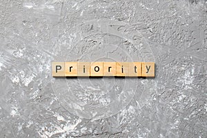 Priority word written on wood block. priority text on table, concept