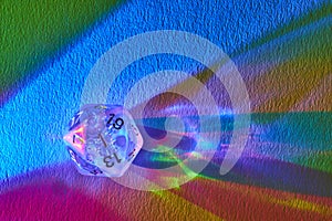Prismatic D20 Dice on Textured Rainbow Canvas, Macro View