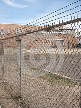 Prison barb wire wall and prison building photo