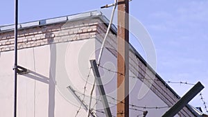 prison barbed wire around lantern pole. jail, restricted area, incarceration