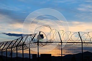 prison barbed wire, at sunset, depression