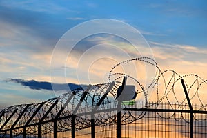 prison barbed wire, at sunset, depression