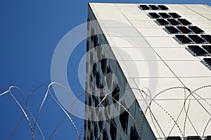 A prison building called  with barbed wire fence