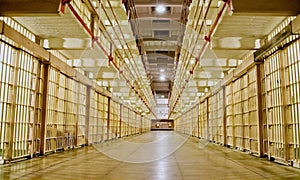 Prison cell block with cells on both sides.