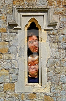 Prison cell faces looking through fort window