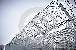 Prison fence. Barbed wire.