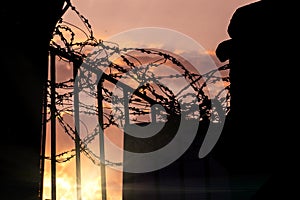 Prison gate with barbed wire - a symbol of repression and non-freedom