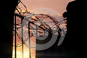 Prison gate with barbed wire - a symbol of repression and non-freedom photo