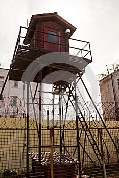 Prison tower and barbed wire fence