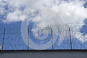 Prison wall and fence, barbed wire