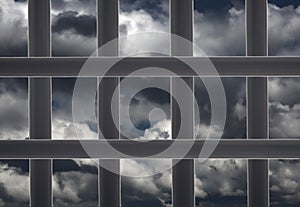 Prison window cell and cloudy sky