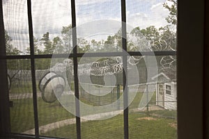 Prison yard with razor wire, guard house and satellite dishes