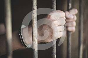 A prisoner catch a steel cage in a cell, Prisoners and police co