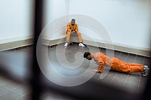 prisoner doing push-ups on floor