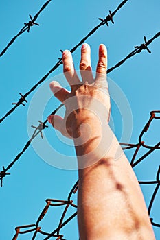 Prisoner hand holding iron bar