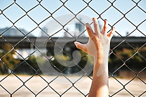 Prisoner hand holding iron bar