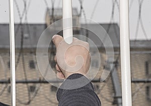 Prisoner at the window of a prison cell