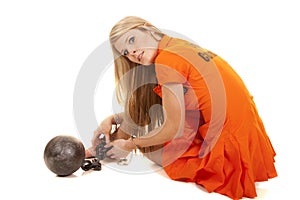 Prisoner orange ball cuffs sit look back