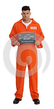 Prisoner in orange jumpsuit with mugshot letter board on white background