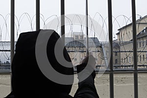 Prisoner at the window of a prison cell