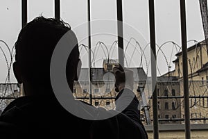 Prisoner at the window of a prison cell